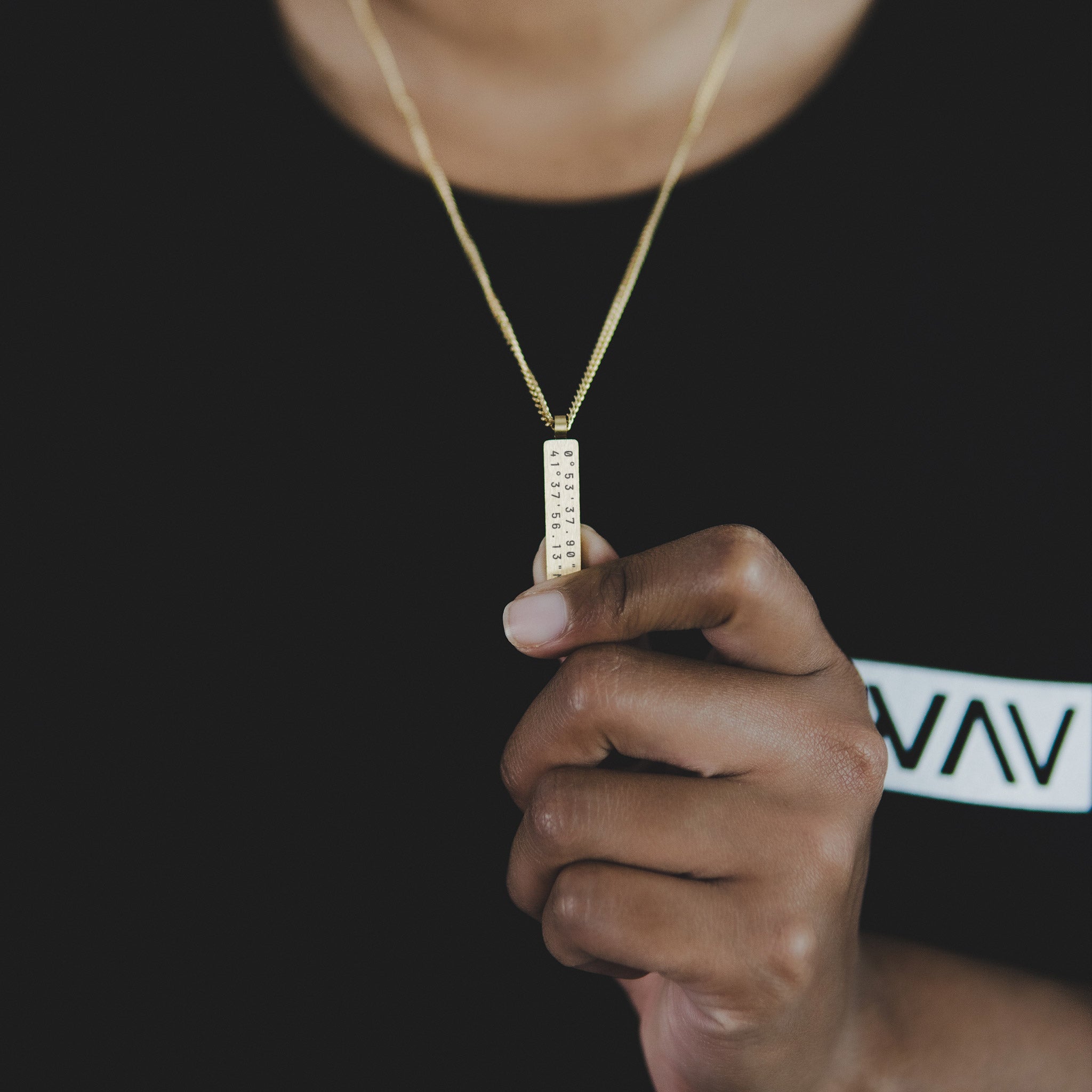 Custom Necklace Bar on a woman, made of stainless steel 316L with 18k gold PVD plating, customized and personalized with Morse code, coordinates, names, initials, dates, or custom text. Minimalist unisex jewelry