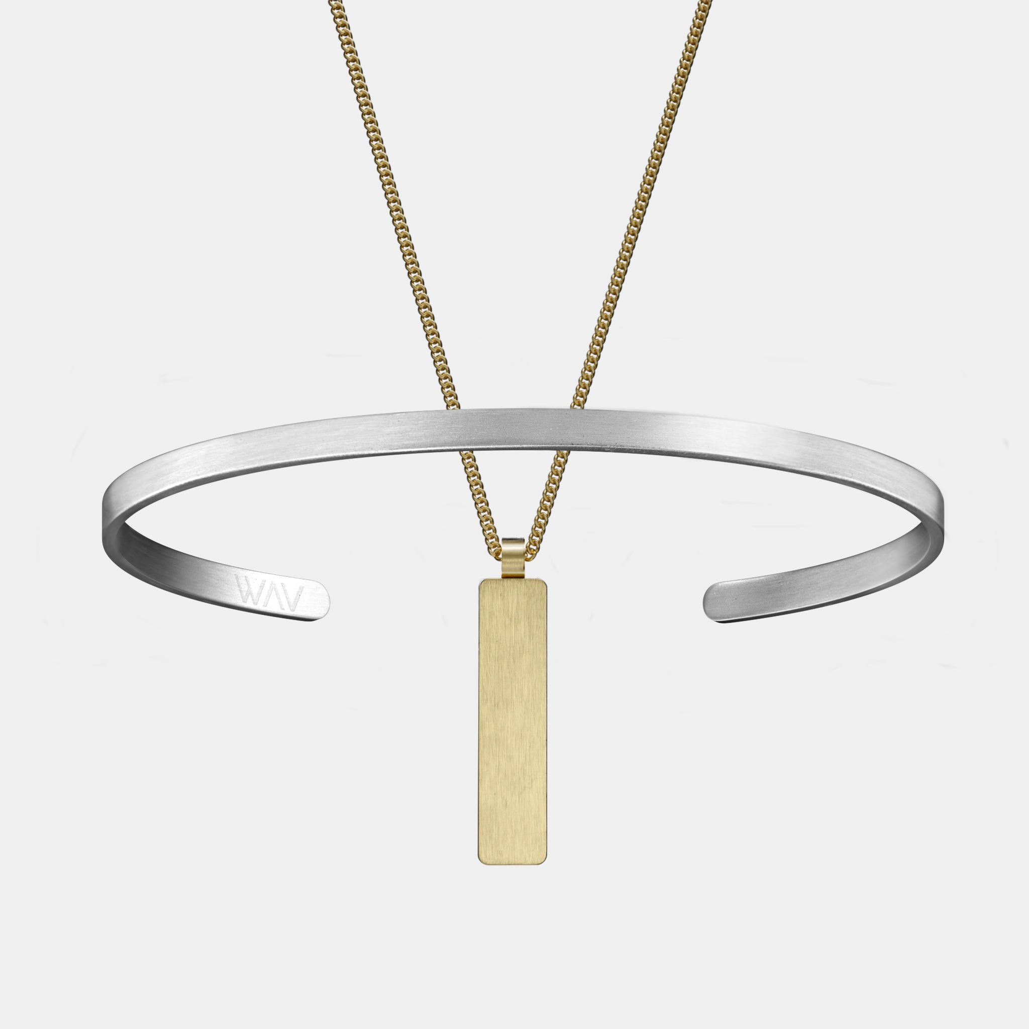 The WAV Custom Cuff + Necklace Bundle features a silver choker with an open front and a thin gold chain adorned with a flat, rectangular pendant. Displayed on a white background, these pieces make ideal personalized jewelry gifts.