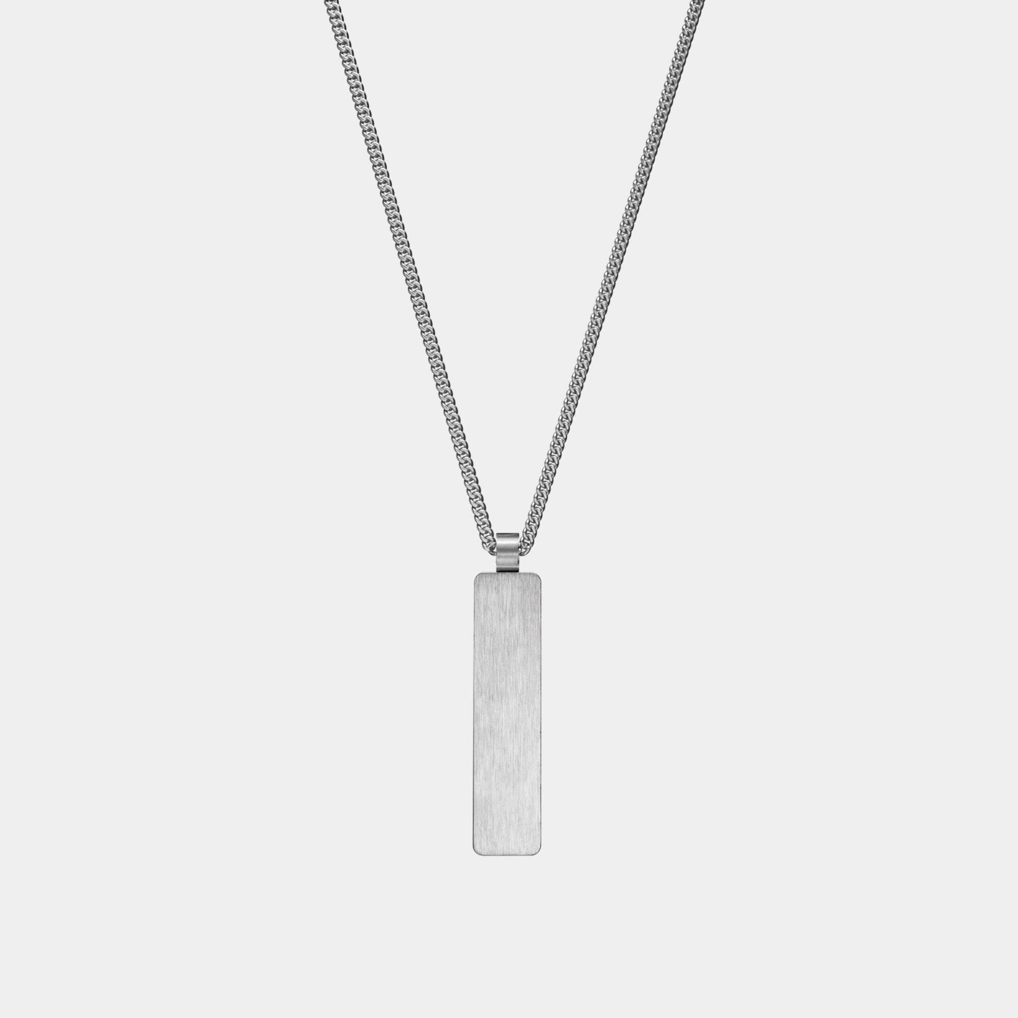 The WAV Custom Necklace Bar is a silver rectangular pendant on a long, thin chain with a brushed metal finish. It hangs vertically against a plain white background, perfect for adding personal touches or commemorating special moments with engraved details.