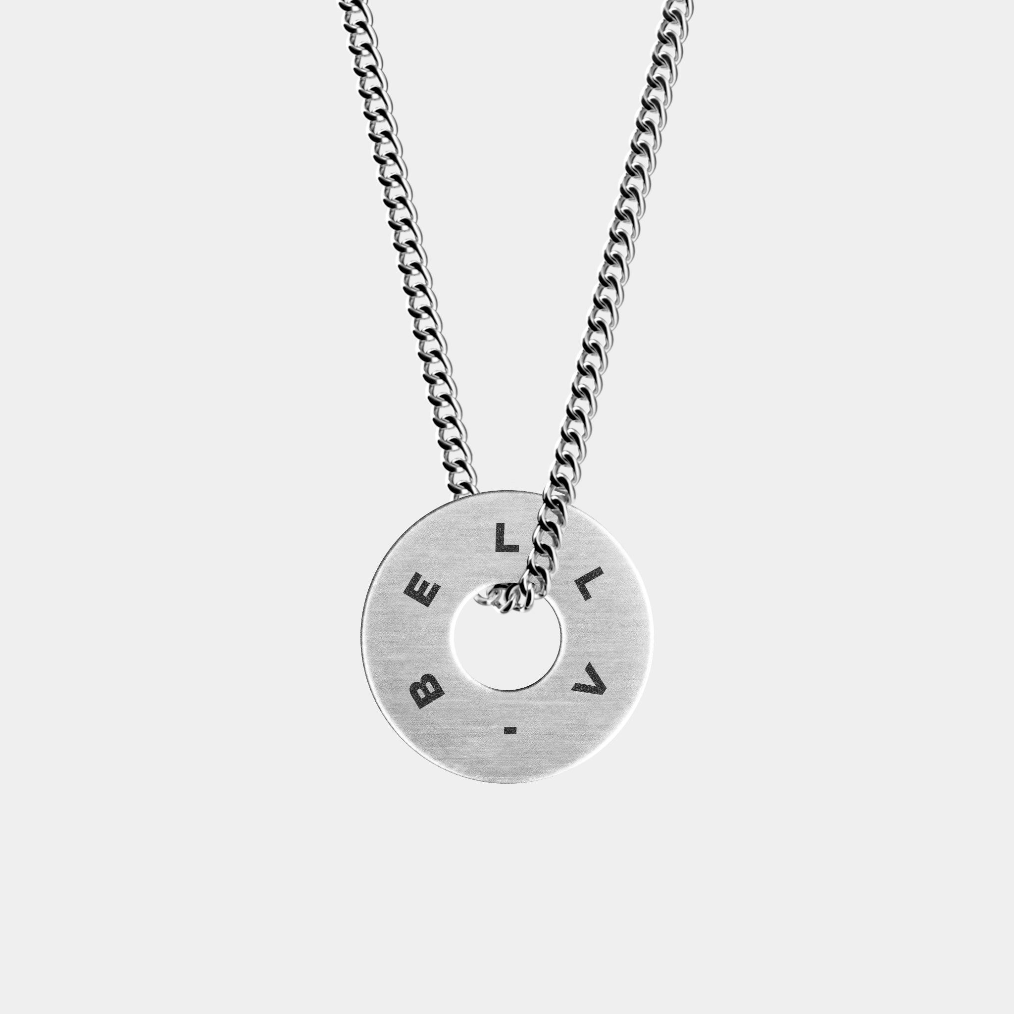 The WAV Custom Necklace Ring is a silver necklace with a pendant engraved with BELLA, showcasing custom jewelry. It has a cut-out circle center and hangs from a classic link chain, highlighted against the light gray background as a beautiful jewelry gift.