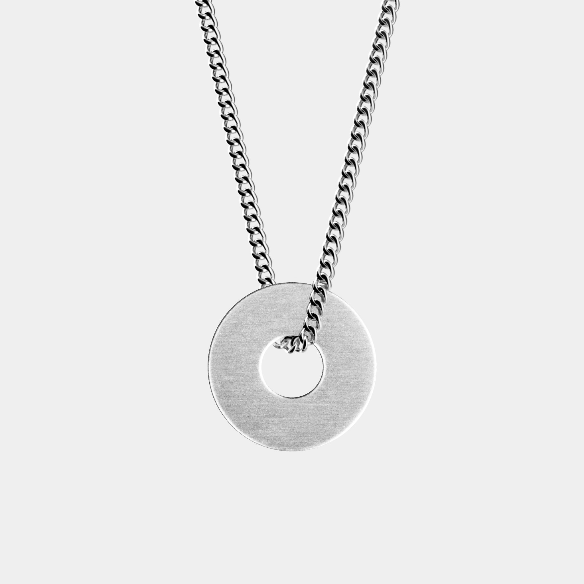 The Custom Necklace Ring by WAV is a stunning silver piece featuring a flat, circular pendant with a central hole threaded through a silver chain. It beautifully contrasts against a plain gray background, making it an ideal jewelry gift for any occasion.